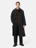 Model is standing in studio is wearing the A.PRESSE Maxi Length Washed Silk Balmacaan Coat in Black 