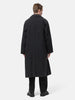 Rear shot of the Model standing in studio wearing the A.PRESSE Maxi Length Washed Silk Balmacaan Coat in Black 