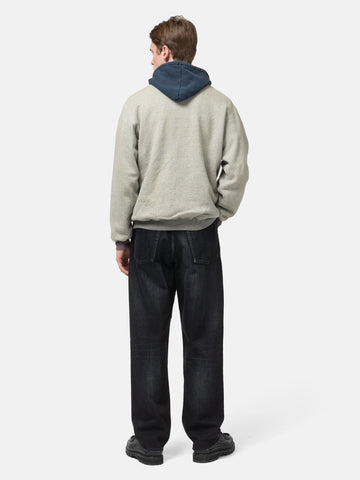 Rear view of the Model standing in studio wearing the A.PRESSE Vintage Attached Hood Sweat Parka in Oatmeal