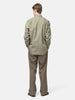 Rear view of the Model standing in studio wearing the AURALEE Washed Finx Twill Shirt in Olive
