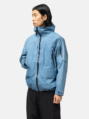 Half-body shot of the Model wearing the Spectre Jacket in GORE-TEX 3L Nylon Hand Dyed Indigo