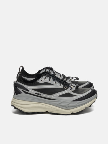side view of the HOKA Stinson One7 Stellar Grey / Eggshell
