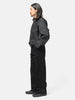 Side view of the model wearing the LEMAIRE Wide Pants Black