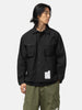 Half body shot of the model wearing the Neighborhood Fatigue Shirt LS Black