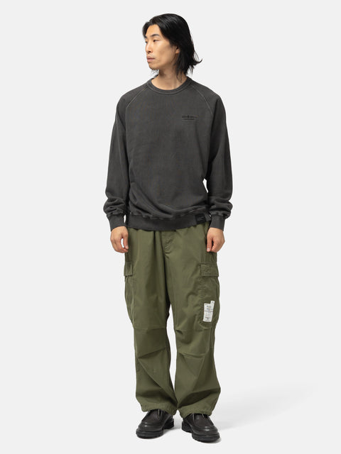 Full body shot of the model wearing the Neighborhood Pigment Dyed Sweat Shirt LS Black