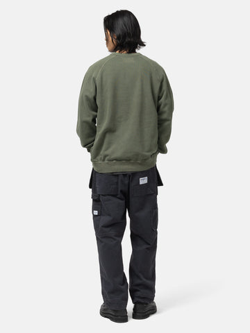 Back of the model wearing the Neighborhood Pigment Dyed Sweat Shirt LS Olive Drab