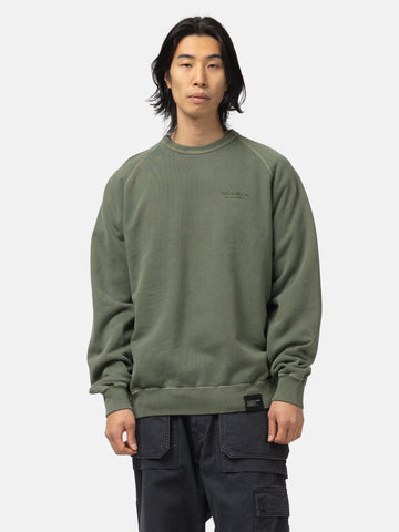 Half body of the model wearing the Neighborhood Pigment Dyed Sweat Shirt LS Olive Drab