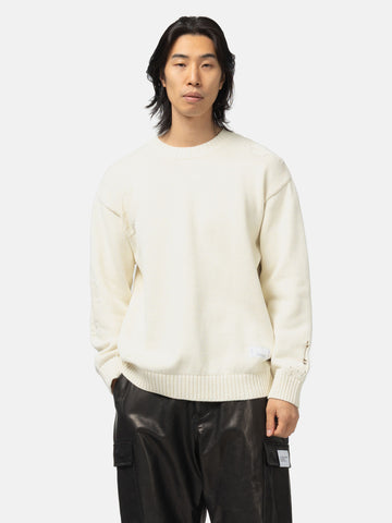 Half body shot of the model in the Neighborhood Savage Crewneck Sweater White
