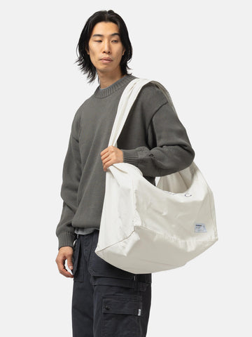 Model wearing the Neighborhood Solid Newspaper Bag Ivory