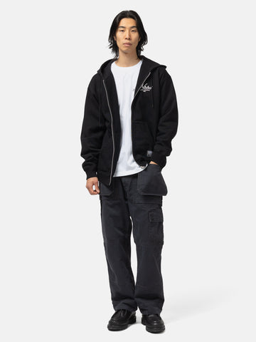 Full body shot of the model wearing the Neighborhood Staple Sweat Zip Hoodie LS Black