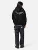 Back shot of the model wearing the Neighborhood Staple Sweat Zip Hoodie LS Black