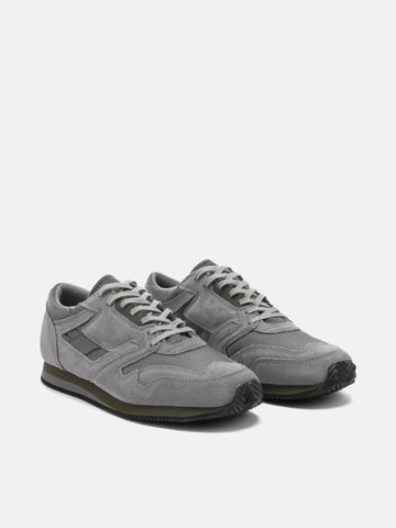 Three quarter view of the Reproduction of Found British Military Trainer in Grey premium suede and nylon photographed in studio.