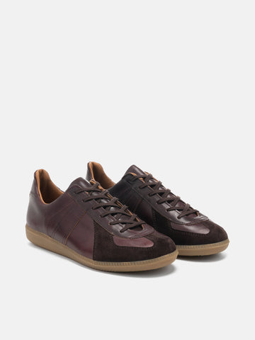 Three-quarter view of the Reproduction of Found German Military Trainer in Burgundy Horween Chromexcel leather photographed in studio.