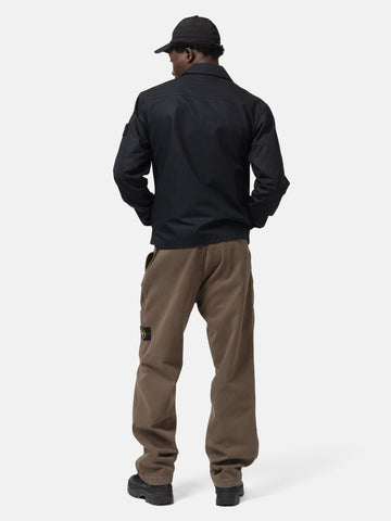 Back shot of the model wearing the Stone Island Ghost Piece All-Weather Cotton Canvas Overshirt Black