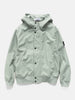 Flat shot of the Stone Island Light Soft Shell-R_E.Dye® Technology Hooded Jacket Sage
