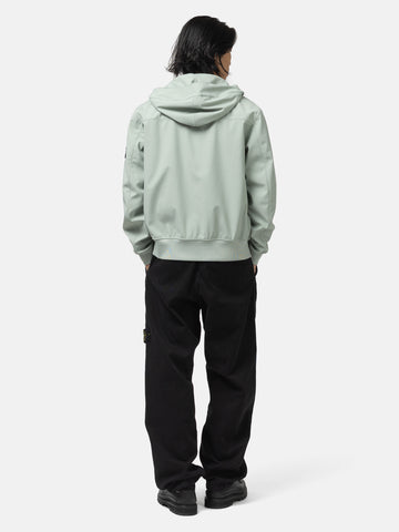 Back shot of the model wearing the Stone Island Light Soft Shell-R_E.Dye® Technology Hooded Jacket Sage