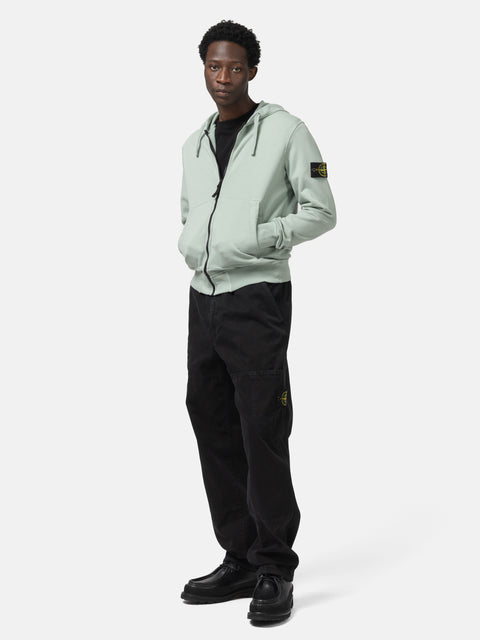 Full body shot of the model wearing the the Stone Island Organic Cotton Hooded Sweatshirt Sage