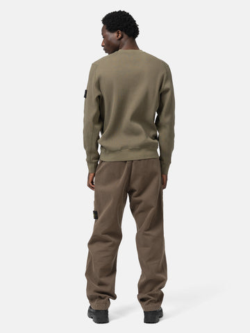 Back shot of the model wearing the Stone Island Organic Cotton Waffle Fleece Crewneck Military Green