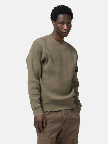 Half body shot of the model wearing the Stone Island Organic Cotton Waffle Fleece Crewneck Military Green