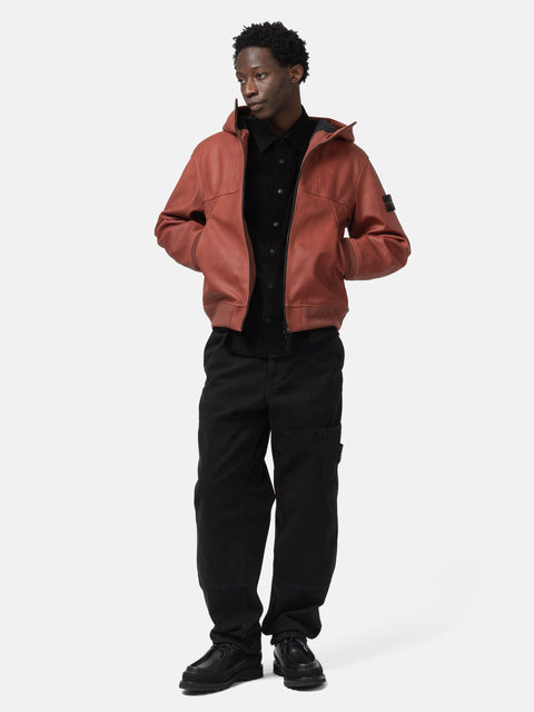 Full body shot of the model wearing the Stone Island Textured Leather Hooded Jacket Brick Red