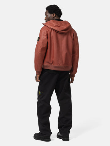 back shot of the model wearing the Stone Island Textured Leather Hooded Jacket Brick Red