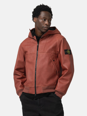 half body shot of the model wearing the Stone Island Textured Leather Hooded Jacket Brick Red
