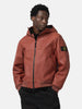 half body shot of the model wearing the Stone Island Textured Leather Hooded Jacket Brick Red