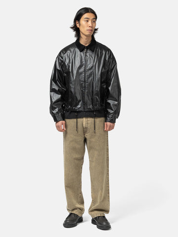 Model standing in studio wearing the Cotton Poplin Zip up Blouson from URU in studio