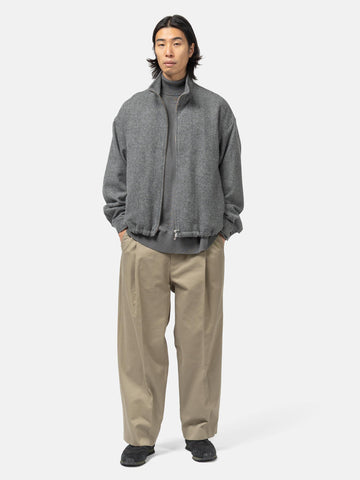 Full shot of the model standing in studio wearing the URU Organic Cotton Chino 1 Tuck Pants