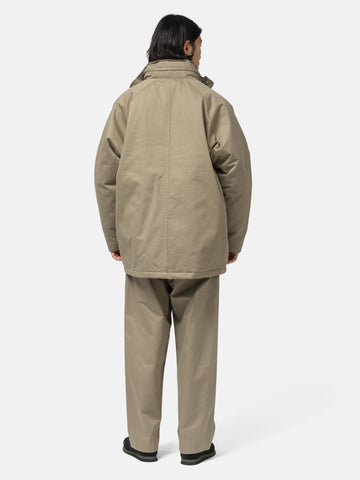 Rear shot of the Model standing in studio wearing the organic cotton chino half coat from URU.