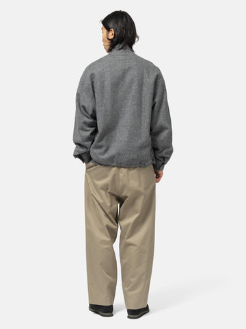 Rear view of the model wearing the wool light tweed zip-up blouson from URU.