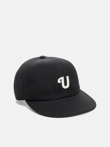 Shot in studio of the UNLIKELY Team Cap in Black