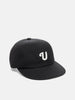 Shot in studio of the UNLIKELY Team Cap in Black
