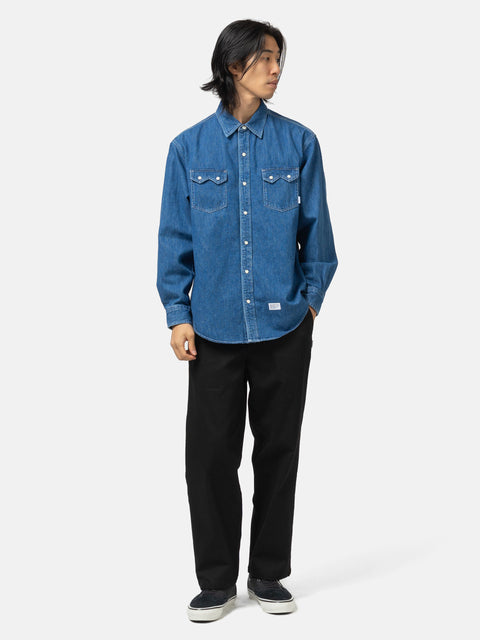 Full body shot of the model wearing the WTAPS Allman / LS / Cotton. Denim Indigo