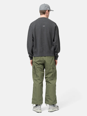 Rear view of the Model standing in studio wearing the WTAPS Crewneck Sweater in NYCO Black