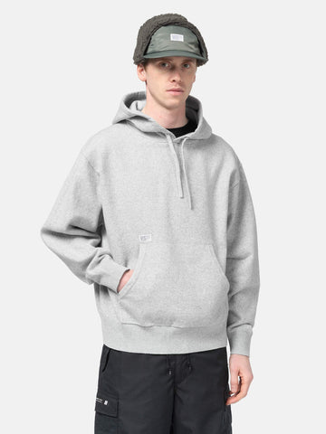 Half body shot of the Model standing in studio wearing the WTAPS Hoodie Sweater in NYCO Gray