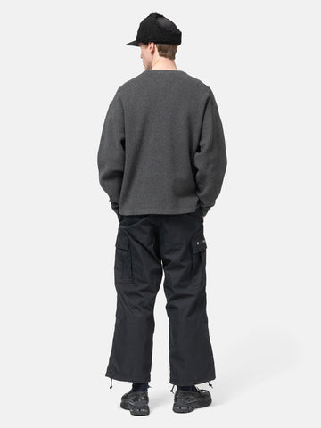 Rear view of the Model standing in studio wearing the WTAPS KRS UPR Sweater in NYCO Black
