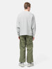 Rear view of the Model standing in studio wearing the WTAPS KRS UPR Sweater in NYCO Gray