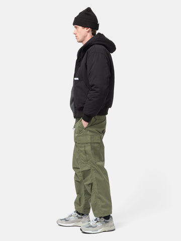 Side view of the Model standing in studio wearing the WTAPS MILT9601  Trousers NYCO Weather in Olive Drab