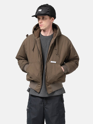 Half body shot of the Model standing in studio wearing the WTAPS Puff Doom Jacket in Cotton Weather Brown