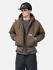 Half body shot of the Model standing in studio wearing the WTAPS Puff Doom Jacket in Cotton Weather Brown