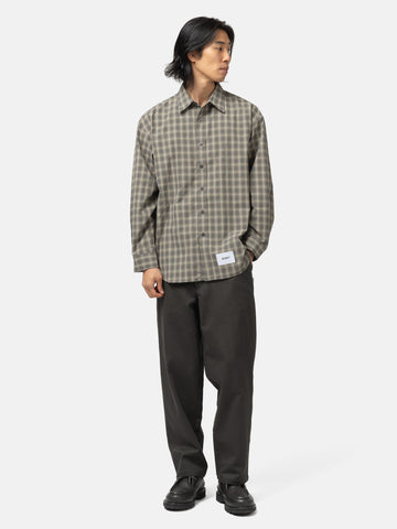 full body shot of the model wearing the WTAPS Txt 01 / LS / Poly. Broadcloth. Textile. Of Olive Drab