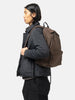 Model is wearing the HOBO Backpack 22L Nylon Oxford Onibegie Dyed Brown