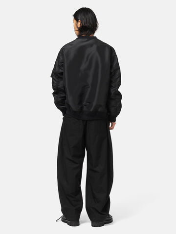 rear view of the model wearing the sacai Cotton Typewriter Pants Black