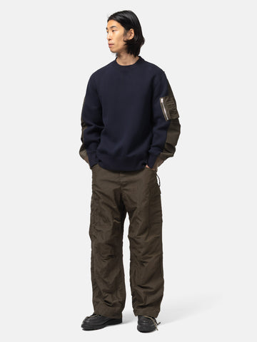 Full-body view of the model wearing the sacai Sponge Sweat Pullover Navy x Khaki