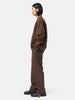 Side-body view of the model wearing the sacai Suiting Pants Brown