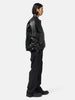 side-body view of the model wearing the sacai Weathercloth Pants Black
